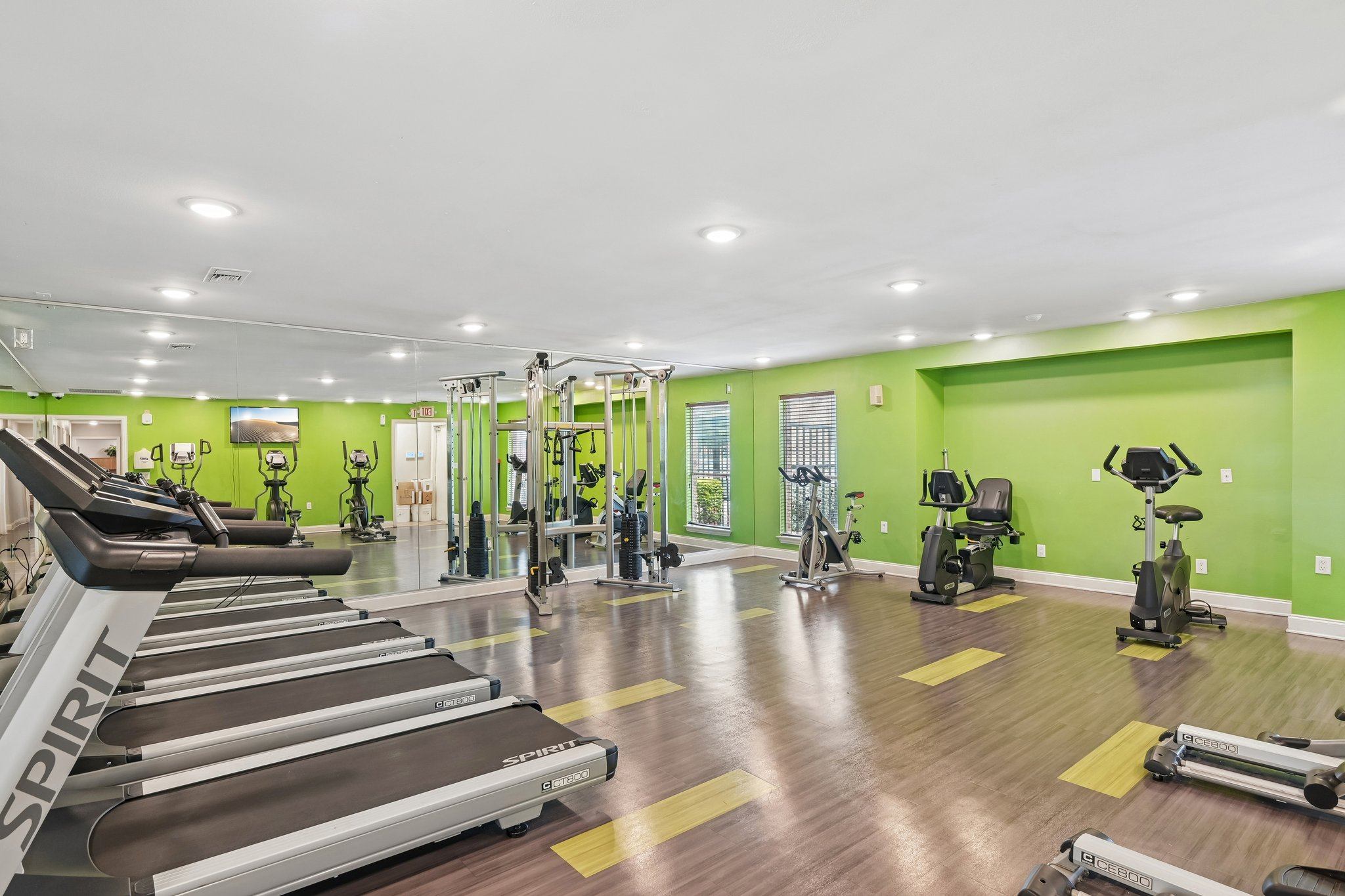 A gym with treadmills and exercise bikes.